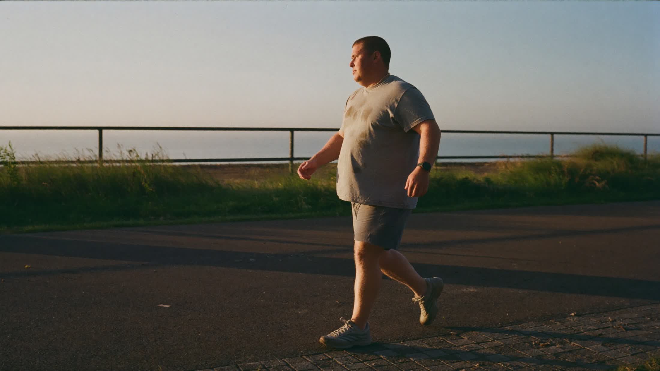 A member out walking a coastal path in early morning light